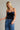 Isti Top strapless navy velvet top front view with jeans.