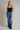 Isti Top strapless navy velvet top full body front view with jeans.