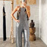 Model wearing silver sequin Jazmin Jumpsuit with flowy leg and side slit — Matte Concept Store
