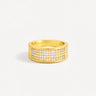 Josie Ring gold wide pave band ring with rows of clear zirconia stones bold statement ring on neutral background.