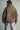 Back view of the Karls Jacket in taupe, showing oversized diamond quilting, a padded stand collar, and a relaxed fit.