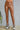 Kaya Faux Leather Leggings high shine caramel fitted leggings front view full length.