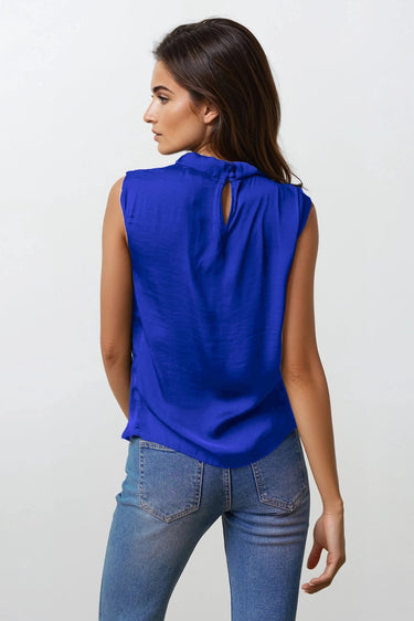 Kian Top worn by model, back view, showing sleeveless cut and relaxed draped fit in blue fabric.