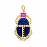 Kina Pendant gold scarab charm with deep blue enamel wings and pink top stone front view on neutral background showing intricate detailing and polished finish.