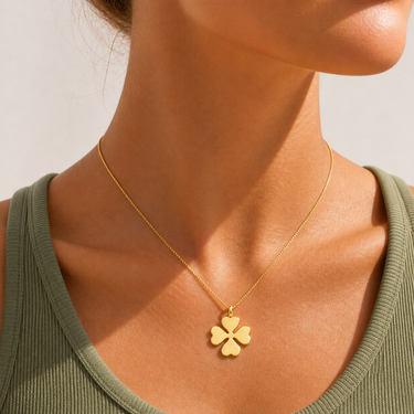 Kinat Necklace worn on model showing delicate chain and clover pendant sitting at collarbone.