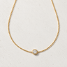 Kopa Necklace featuring a delicate gold-filled chain with a round cubic zirconia solitaire pendant, styled on a light neutral background showcasing its timeless, minimalist design for everyday layering.