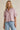 Lad Shirt styled with light pink shirt and blue jeans front view on model.