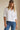 Lad Shirt white relaxed-fit button-down styled with blue jeans front view on model.