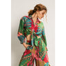 Lein Shirt styled with a vibrant tropical print and tie-front button-down design