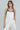 Model wearing the Lennon two-tone ivory satin cami with black faux-leather accents.
