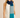 Woman wearing Linda Scarf in color-block blue and teal knit, styled over a white sleeveless top.