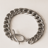 Link Bracelet — polished silver chain bracelet with bold toggle clasp on beige marble background, modern jewelry by Matte.