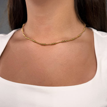 Model wearing Lioraz gold plated textured chain necklace by Matte, elegant and adjustable