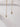 Long gold lightning chain stud earrings hanging against white wall — edgy and lightweight design by Matte
