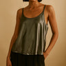 Loel Tank Top — grey satin tank with glossy finish and relaxed drape, model wearing in studio lighting, styled with black trousers by Matte.