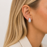 Lum Stud Earrings silver teardrop stud earrings worn on model, showing sculpted textured finish and bright polished shine.