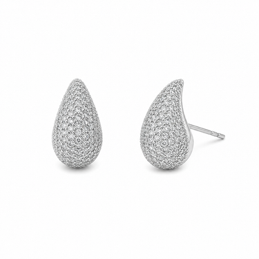 Lum Stud Earrings silver teardrop studs on neutral background, showing slim silhouette and textured surface.
