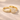 Lumi Stack Ring pavé band ring with shimmering cubic zirconia stones and a cluster ring in gold finish delicate stacking ring on neutral background