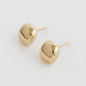 Maelis Stud Earrings — gold plated sculptural stud earrings with rounded square shape and mirror finish on beige linen background, elegant jewelry by Matte.