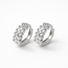 Pair of Magal silver huggie earrings with geometric stone design on a white background by Matte