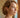 Woman wearing polished gold hoop earrings with a sleek lightweight design, styled in a natural lifestyle portrait with soft warm lighting - Matte Jewelry
