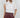 Maratea Blouse worn by model, front view, featuring asymmetric drape and relaxed elegant fit.