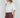 Maratea Blouse worn by model, angled view, showing fluid drape and modern sleeveless silhouette.