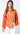 Maréa Blouse sunset-orange statement blouse with artistic tropical-inspired print, button front detail, and relaxed fit long sleeves, styled on model with white pants against clean studio background.