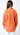 Maréa Blouse back view showing loose drape and full tropical print design across the fabric, long sleeves with relaxed fit, styled with crisp white pants for a resort-inspired outfit.