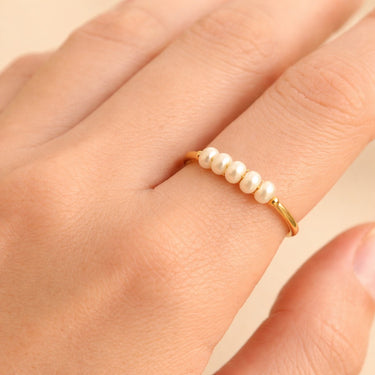 Gold Freshwater Pearl Ring with Five Pearls worn on hand – delicate gold band with small white pearls on finger, minimal jewelry styling close-up