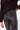 Close up of sparkling black sequin flare pants with fitted waist and shimmering texture, bold night-out piece