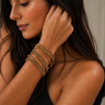Mausi Bracelet gold multi-layer wrap bracelet with delicate crystal beading and slim strands, styled stacked on wrist for a layered, shimmering look