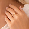 Woman wearing the Mercedes Ring by Matte, a delicate gold beaded stretch ring with polished mirror-finish beads, styled on hand with soft natural lighting.