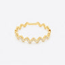 Mia Ring gold zigzag band with pavé stones front view on light neutral background showing geometric wave silhouette and delicate sparkle