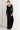 Model wearing Midnight Lace Pants with black ribbed long-sleeve top and heels, styled for an elegant evening outfit.