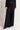 Model wearing Midnight Lace Pants in black lace with satin waistband, styled with matching lace blazer and pointed heels.