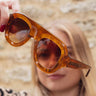 Mirage Sunglasses tortoiseshell oversized sunglasses worn on model warm-toned statement eyewear.