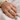 Morris Ring styled on hand with stacked gold rings, showcasing modern layered jewelry look.