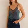 Muna Sequin Top — satin camisole in iridescent teal with bronze sequin neckline, worn by model against neutral wall, Matte Clothing Collection.