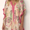 Woman wearing Nairobi Tunic Cover Up in tropical pink and beige print, relaxed fit with fringe detail.
