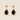 Nodar Stud Earrings gold earrings with black teardrop stones on neutral background, showing polished gold setting and bold contrast design