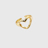Gold heart-shaped ring on a light gray background