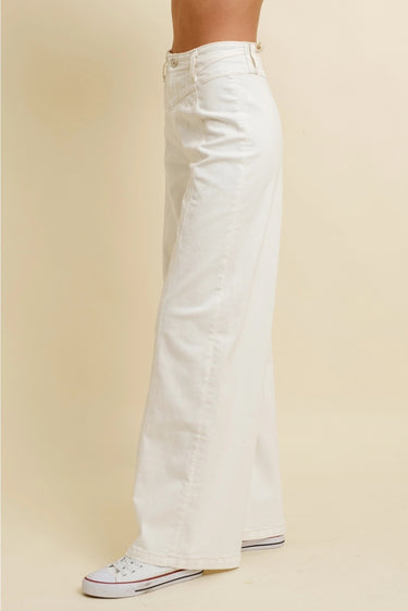 Nurcia Jeans full side view showing structured high-waisted fit, wide-leg cut, and long inseam in crisp cream-toned denim.