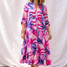 Nusa Maxi Dress vibrant tropical print maxi dress on model full body front view showing flowy silhouette, lightweight fabric, and relaxed summer fit