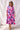 Nusa Maxi Dress vibrant tropical print maxi dress on model full body front view showing flowy silhouette, lightweight fabric, and relaxed summer fit
