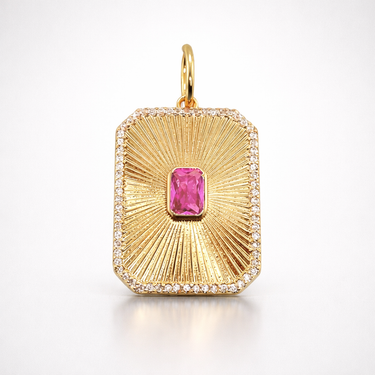 Nuwa Pendant gold rectangular charm with textured sunburst finish and pink center stone on a light gray background with soft shadow