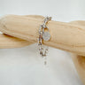 Silver lock chain bracelet on wooden display — Odette Bracelet by Matte.