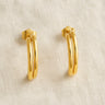 Gold double-band hoop earrings on white linen backdrop, Oli Hoop Earrings.