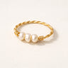 Gold twisted wire ring with three freshwater pearls on a soft neutral background, Olivia pearl ring minimalist gold jewelry.