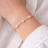 Otawa Bracelet worn on wrist featuring delicate silver chain with pearl details